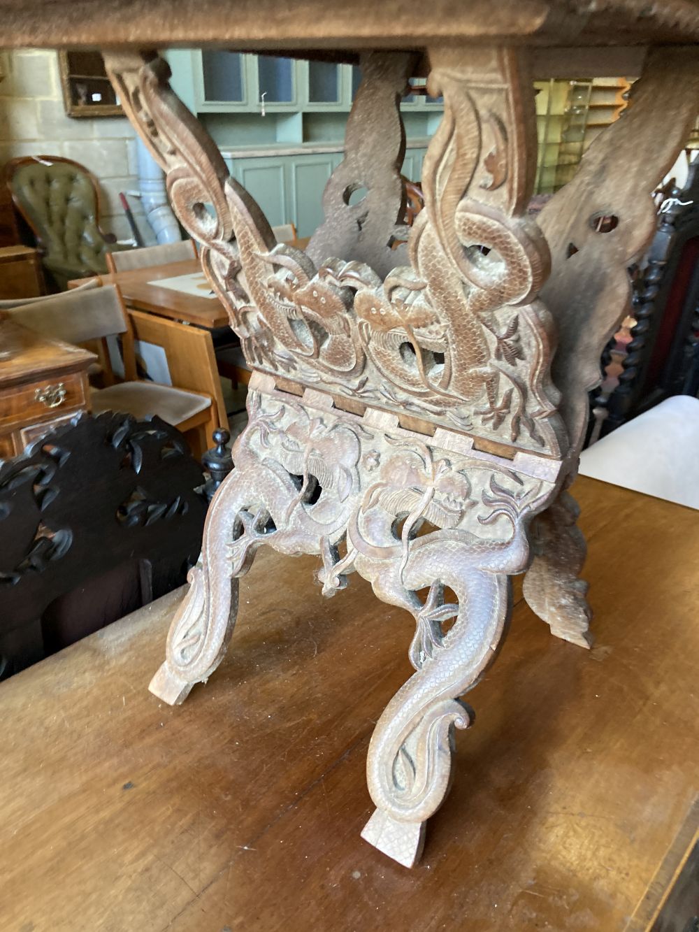 A WWI Sino-Burmese carved teak tray on folding stand,